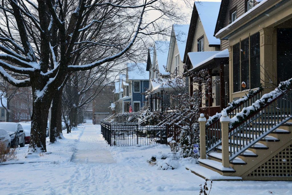 snowy landscape with houses in the background